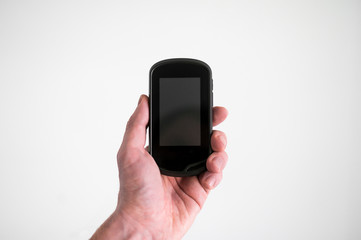 A man holds a navigator in hand on a white background