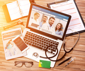 Wood doctor's desk in high definition with laptop, tablet and mo