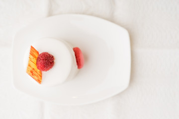 White cake with raspberry top view