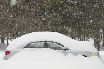Car buried in snow during a heavy snow storm