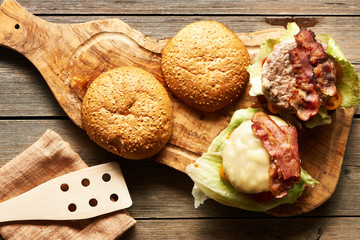 Home made cheeseburgers on wooden table