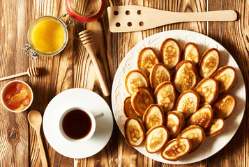 Pancakes or fritters on wooden background