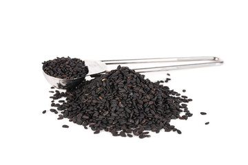 black sesame isolated on white background with copy space. metal measuring spoon of sesame seeds and heap of sesame seeds.