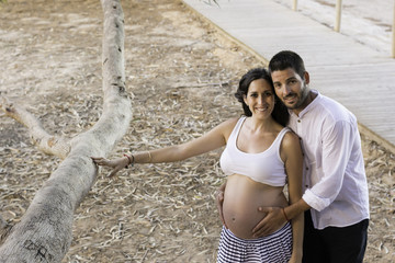Happy pregnant couple .