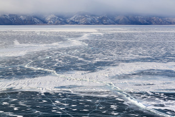 Winter lake landscape with crack on ice