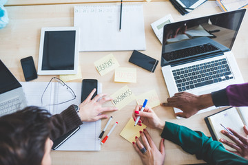 Top view of an office desk with a group of people working using