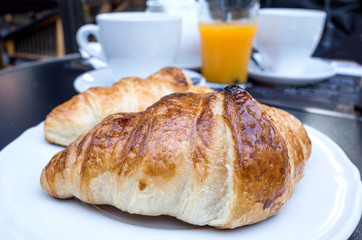 Breakfast with coffee and croissants