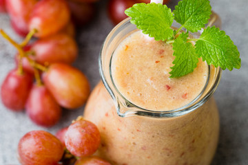 Grape smoothie, on the grey  background.