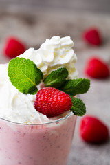 Raspberry milk shake with mint decor.