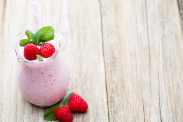 Raspberry milk shake with mint decor.