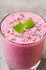 Smoothie, pink juice on the grey  background.