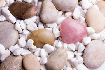 Pink heart stone on the spa stone background.
