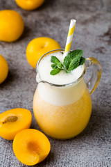 Plum smoothie, on the grey  background.