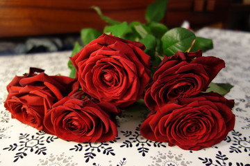 fresh red roses on table