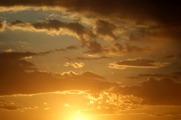 Golden clouds on the sunset sky