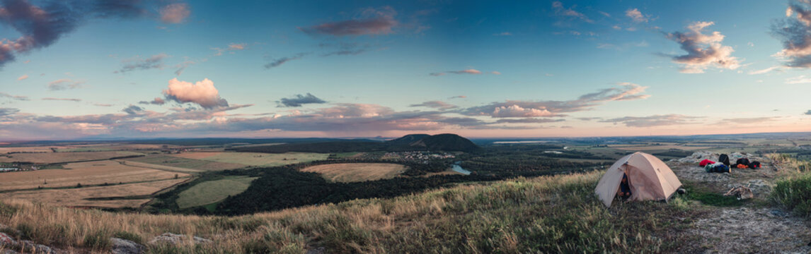 Woman Wild Camping On Grassy Mountain Top