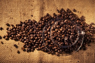 Roasted coffee beans on sackcloth warm tone
