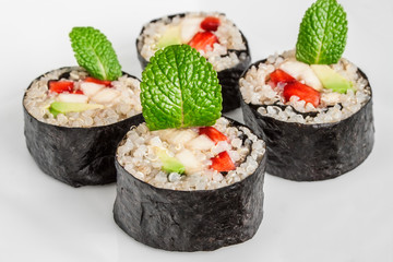 Sweet quinoa sushi rolls with strawberries, banana, avocado and peppermint,