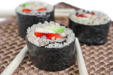Close up image of sweet sushi rolls with quinoa and fruits.
