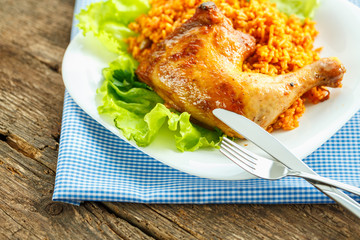 Delicious dish of chicken thigh with rice and salad leaves
