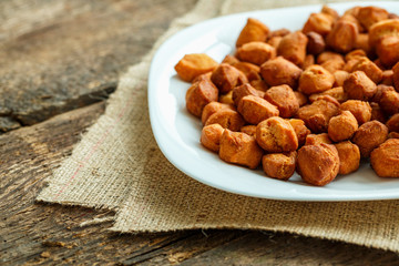 Cookies on a white plate on a sacking on a wooden background