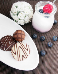 Sweet breakfast, yoghurt with wild berries and chocolate cookies