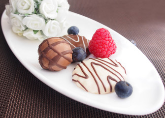 Sweet breakfast, yoghurt with wild berries and chocolate cookies