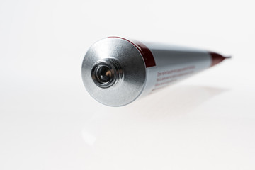 Close up of aluminum tube isolated on white background. Cosmetic or medicine gel.