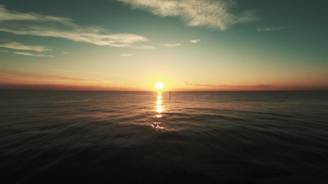 Early morning sun rise view on sea with chill waves airplane and birds fly in sky with white clouds. Looks like romantic lovely evening sunset too