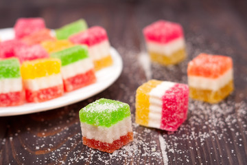 Jelly sweet, flavor fruit, candy dessert colorful on wood background.