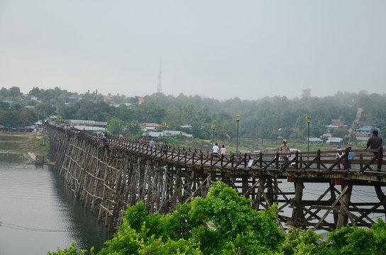 People travel and waiking on Saphan Mon wooden bridge in morning