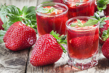 Strawberry juice and fresh berries with mint, selective focus