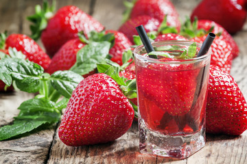 Strawberry juice and fresh berries with mint, selective focus