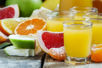 Citrus, cocktail jug, pieces of fruit on a dark background, sele
