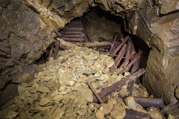 Old abandoned gold mine crushed tunnel passage