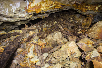 Old abandoned gold mine tunnel passage with stones