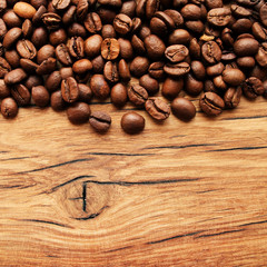 Coffee beans on grunge wooden background