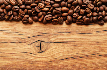 Coffee beans on grunge wooden background