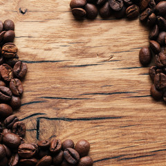 Coffee beans on grunge wooden background