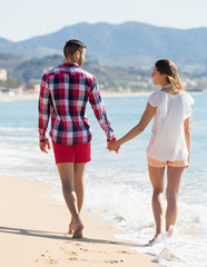 Romantic couple on beach at sunny day.