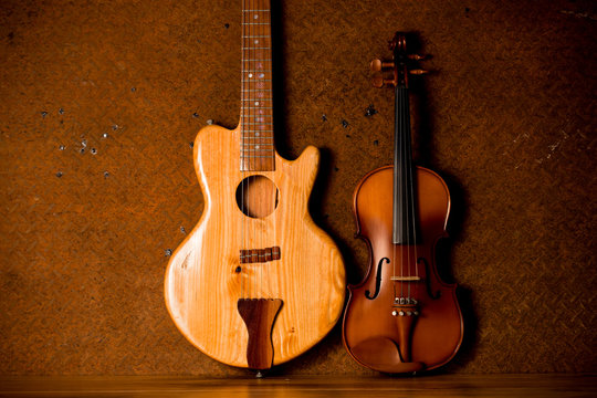 Acoustic guitar and violin on old steel background