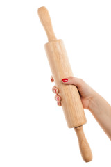 Woman hand with red manicure holding a rolling pin. Isolated on