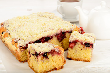 Sweet homemade cake with berries and cup of tea
