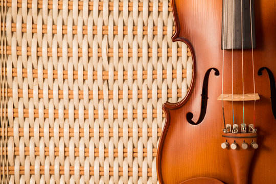 Vintage violin on bamboo weave background with copy space