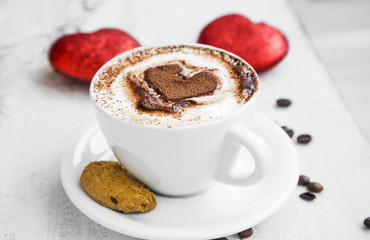 Coffee cup with cream and cocoa heart shape