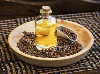Flax seed oil in transparent bottle with flax seeds