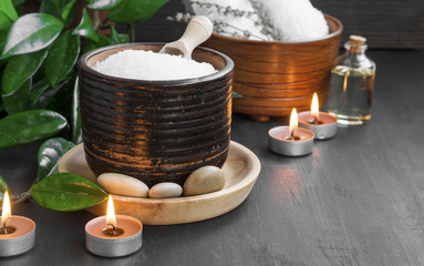 Spa products with bath salt, bath oil, massage stones and candle