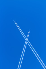 Fototapeta premium Trail of white smoke from the airplane on blue sky