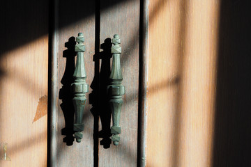 Retro wardrobe handle with shadow in sunlight