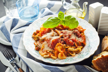 a plate of pasta farfallе with tomato sauce and green peas. hea